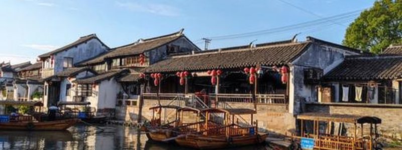 Water-town lane with whitewashed walls and dark tiles — placeholder for Fuyang photography