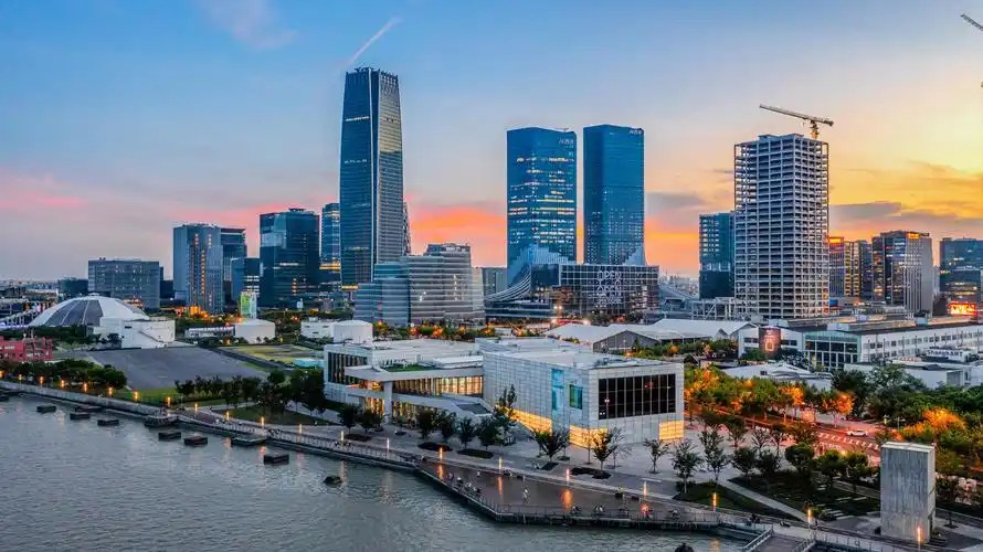 Photo of the Huangpu riverfront with industrial buildings and the skyline beyond