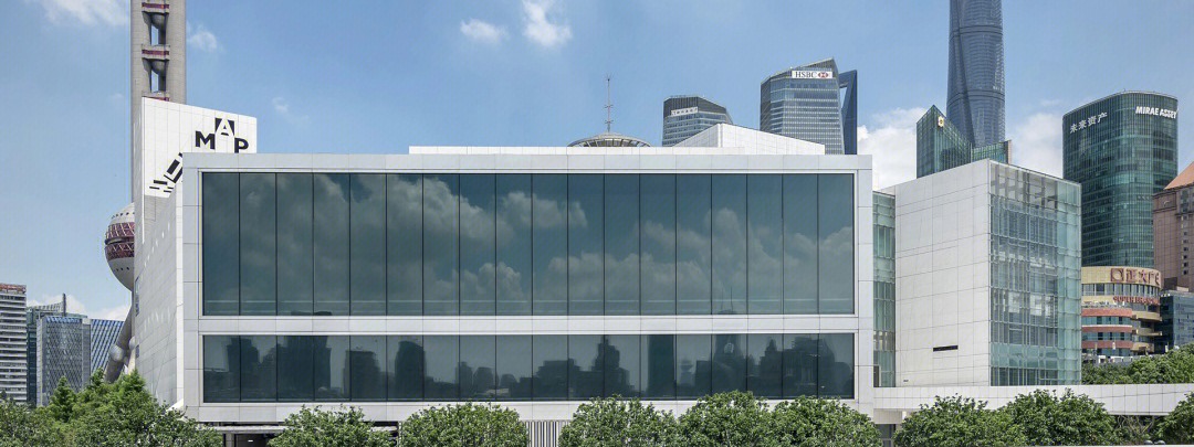 Photograph of the Museum of Art Pudong on the Lujiazui riverfront, with the Oriental Pearl and Shanghai Tower behind it