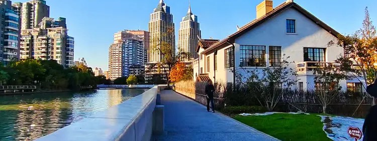 Photo of the cityscape along the Suzhou Creek, with bridges and the skyline beyond