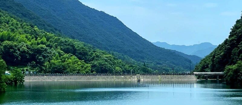 Dayangwu Reservoir with surrounding forested hills in Longwu