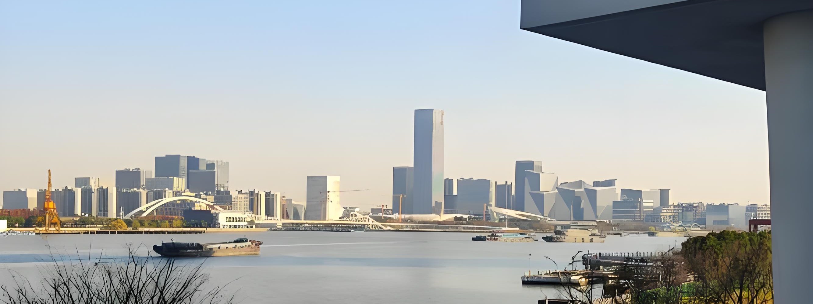 Photo of the cityscape along the Huangpu River with industrial buildings and the skyline beyond