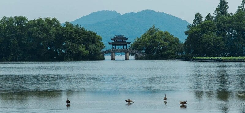 Sunset view of West Lake from Jiuyao Mountain with the heart-shaped route traced in the landscape